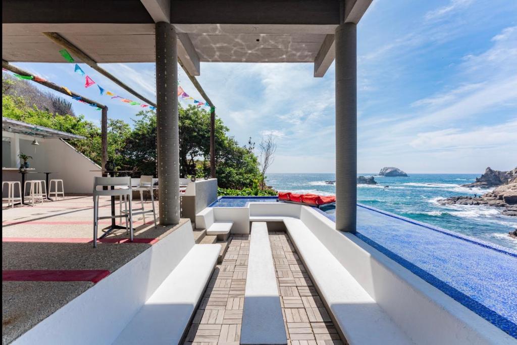 a view of the ocean from a villa with a swimming pool at Villa Aikia (Adults Suites A/C) in Zipolite