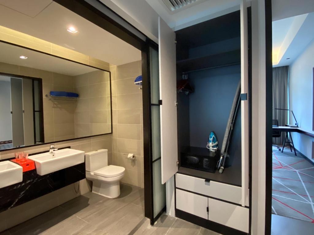 a bathroom with a toilet, sink and shower at the RED One KLCC in Kuala Lumpur