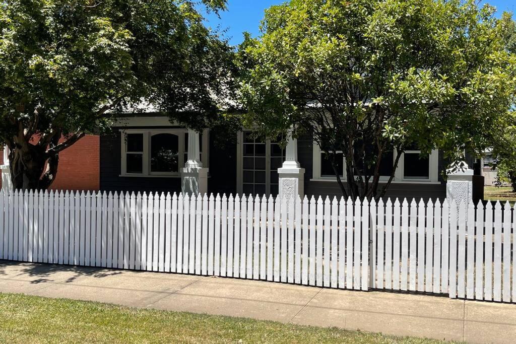 a white picket fence in front of a house at Hazeldene - The Best Location In Town! in Myrtleford