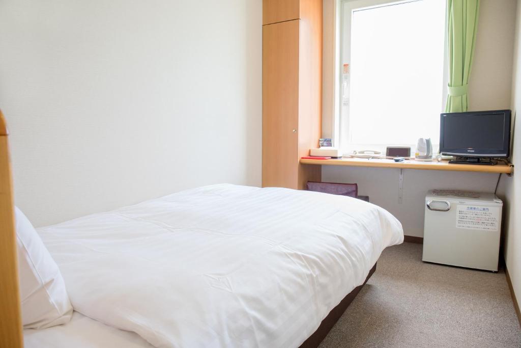 Postel nebo postele na pokoji v ubytování Kur and Hotel Suruga