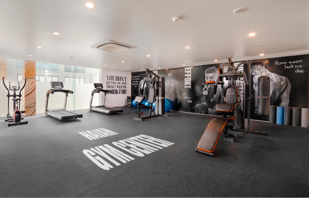 A spacious-looking gym with treadmills, cardio machines and strength equipment.