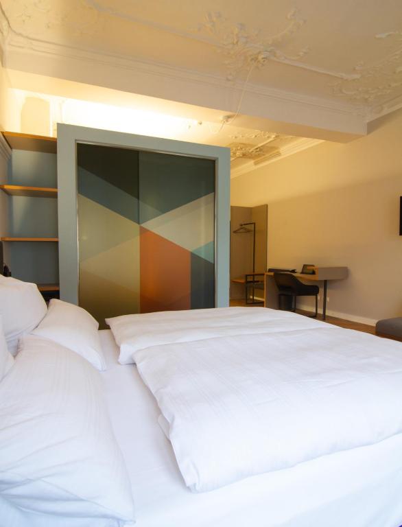 Postel nebo postele na pokoji v ubytování Le Baldinger Boutique Hotel
