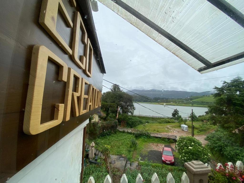 a view of a house with a view of a lake at Eco Creations Nuwaraeliya in Nuwara Eliya
