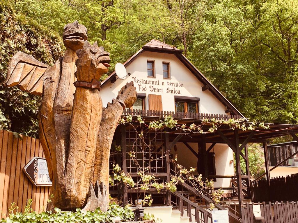 a statue of a bear standing in front of a building at Restaurant a penzion Pod Draci skalou in Karlštejn