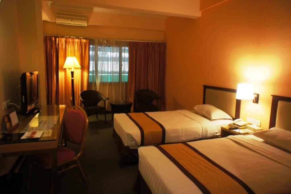Postel nebo postele na pokoji v ubytování Tyng Garden Hotel