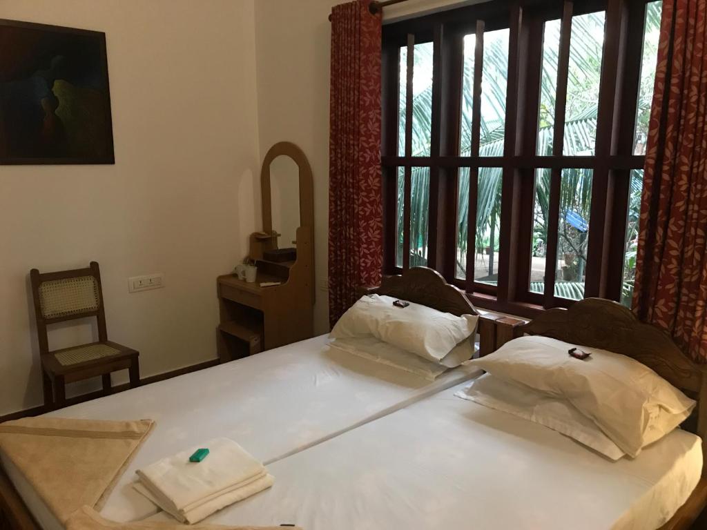 Katil atau katil-katil dalam bilik di Neela Waters - Beach Home