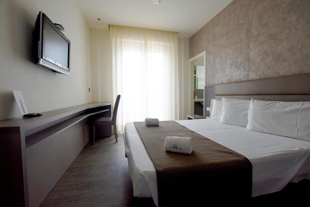 Postel nebo postele na pokoji v ubytování Hotel Aurora