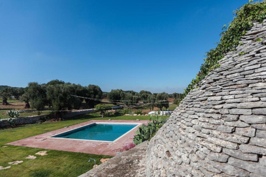 a view from the roof of a stone building with a swimming pool at Masseria Mozzone in Fasano
