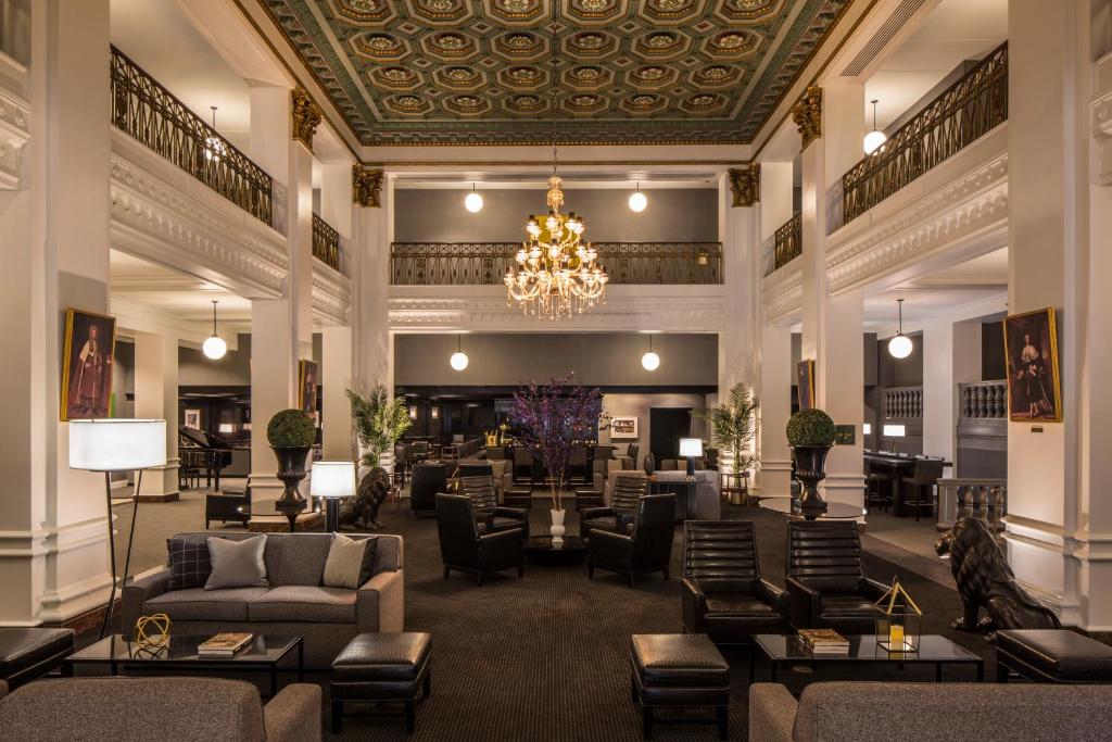 a lobby with couches and chairs and a chandelier at Lord Baltimore Hotel in Baltimore