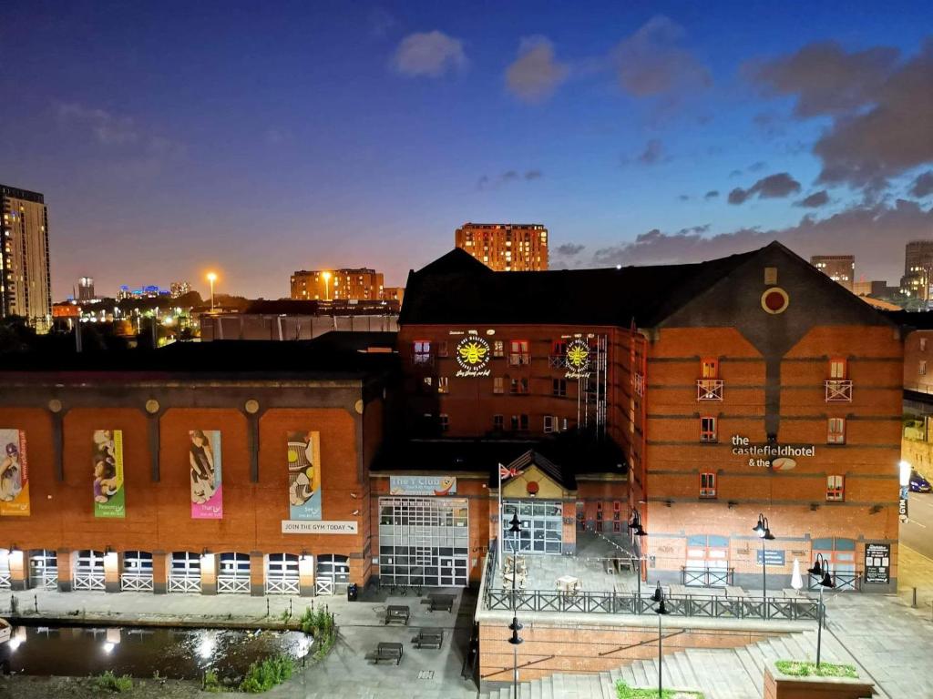 a large building with a sign on the side of it at Castlefield Hotel in Manchester