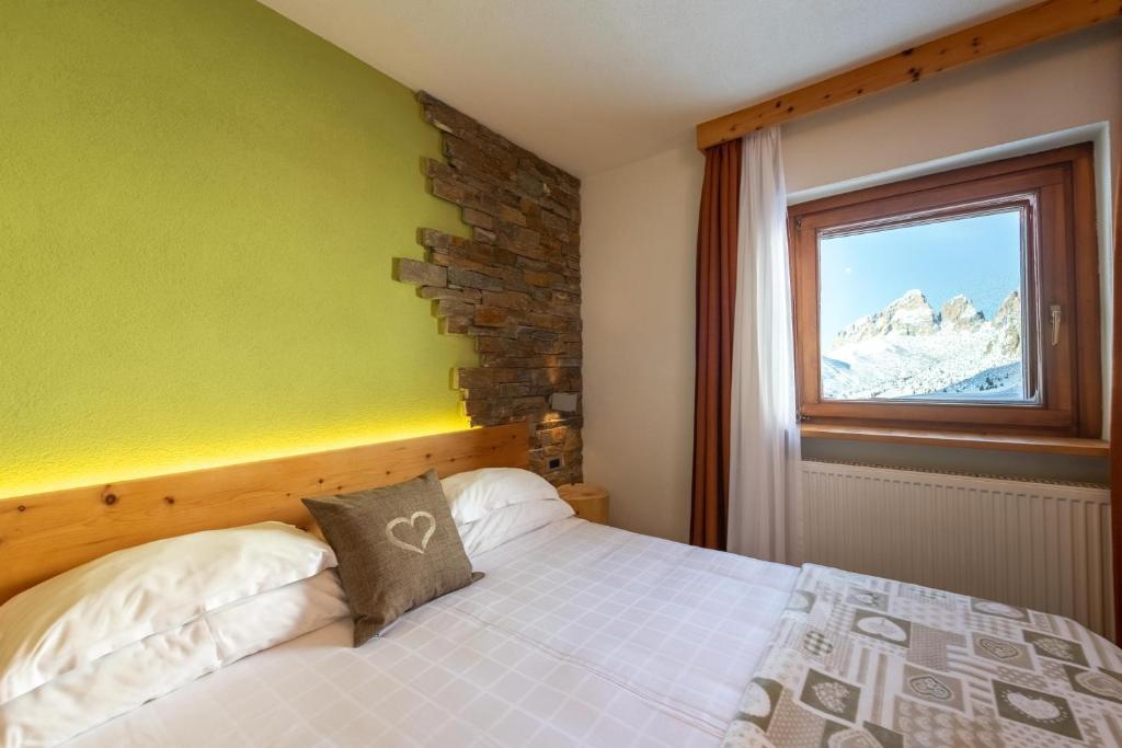 Postel nebo postele na pokoji v ubytování Hotel Col di Lana