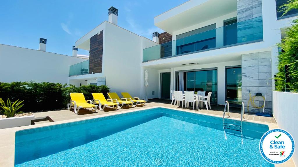 a villa with a swimming pool and a house at Albuhera by Check-in Portugal in Albufeira