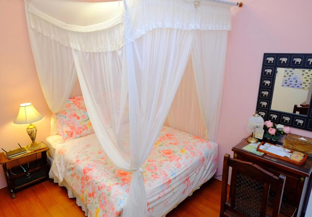 a bedroom with a bed with a canopy at Spring Garden Homestay in Hualien City