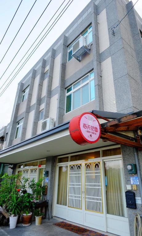 a building with a red sign in front of it at Spring Garden Homestay in Hualien City