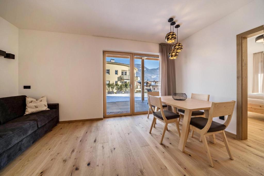 a living room with a table and a couch at Apt Fichte - Nockerhof in Andrian