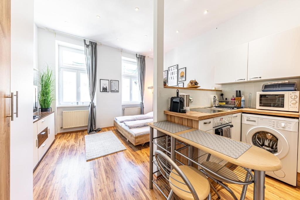 A kitchen or kitchenette at COZY + TRENDY by JR City Apartments