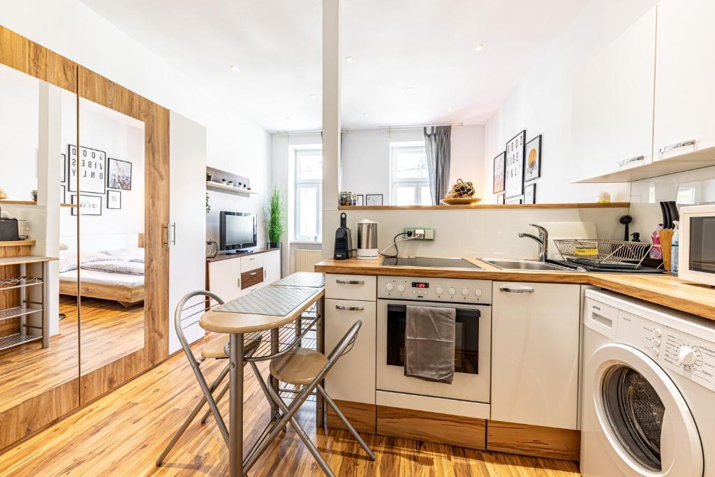 A kitchen or kitchenette at COZY + TRENDY by JR City Apartments