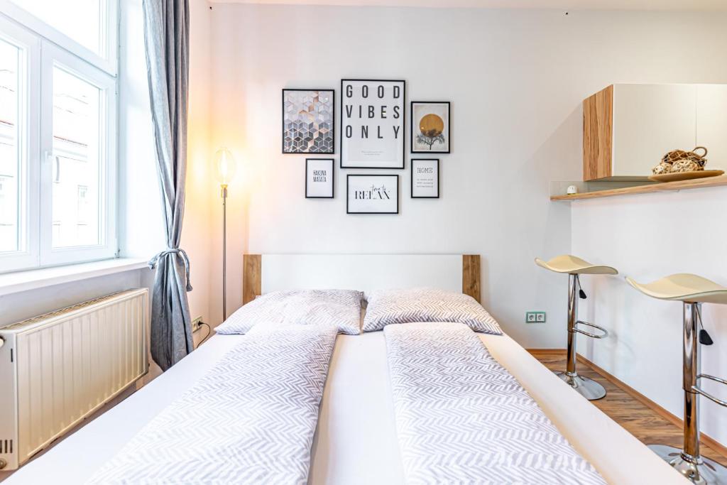 A bed or beds in a room at COZY + TRENDY by JR City Apartments