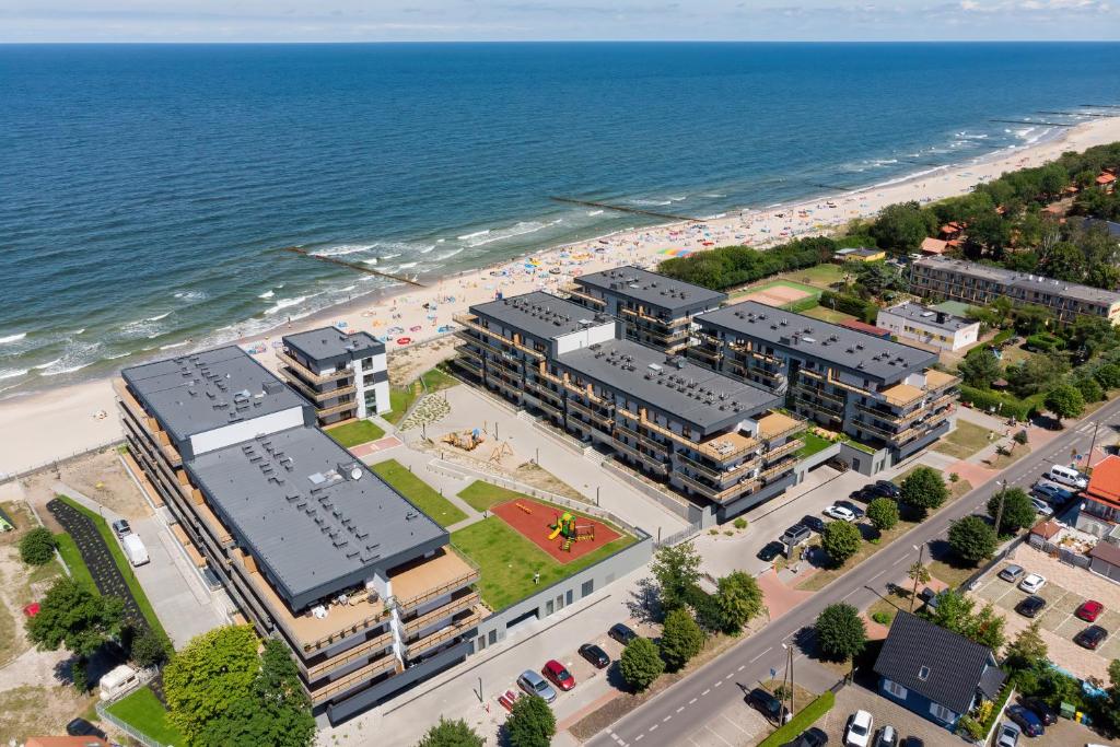 an overhead view of a beach with buildings and the ocean at Apartamenty Gardenia Seaside 2 with Sea View by Renters in Dziwnów