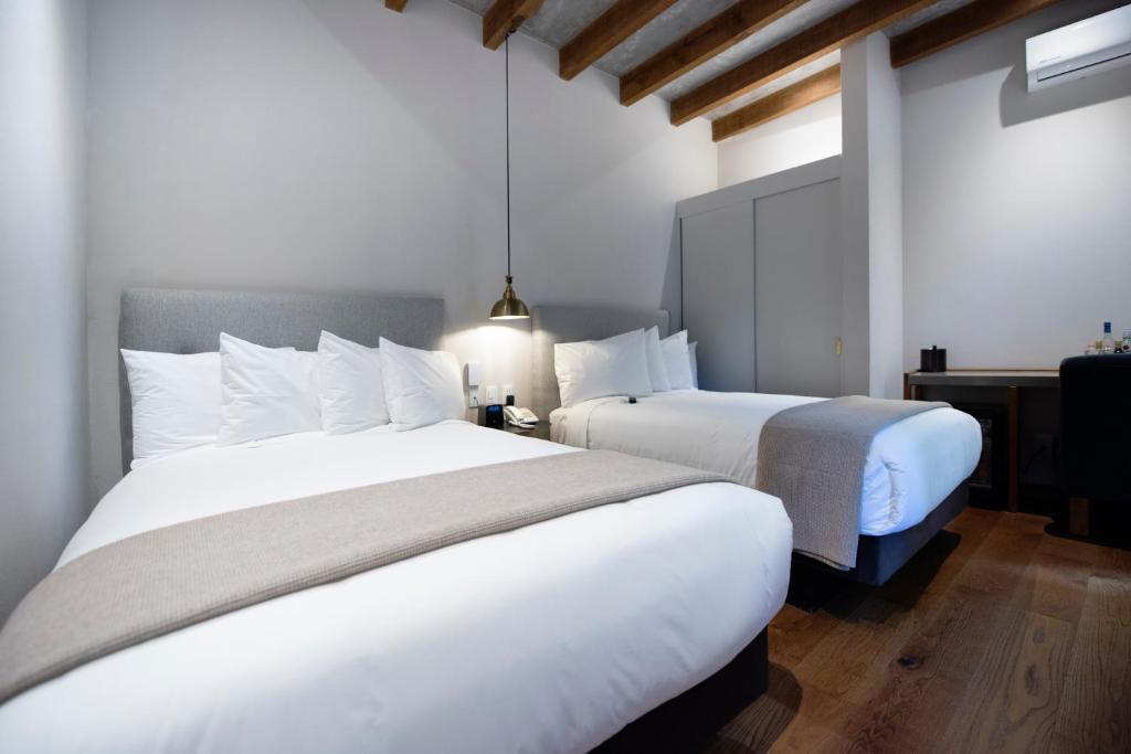 Postel nebo postele na pokoji v ubytování Hotel Madi