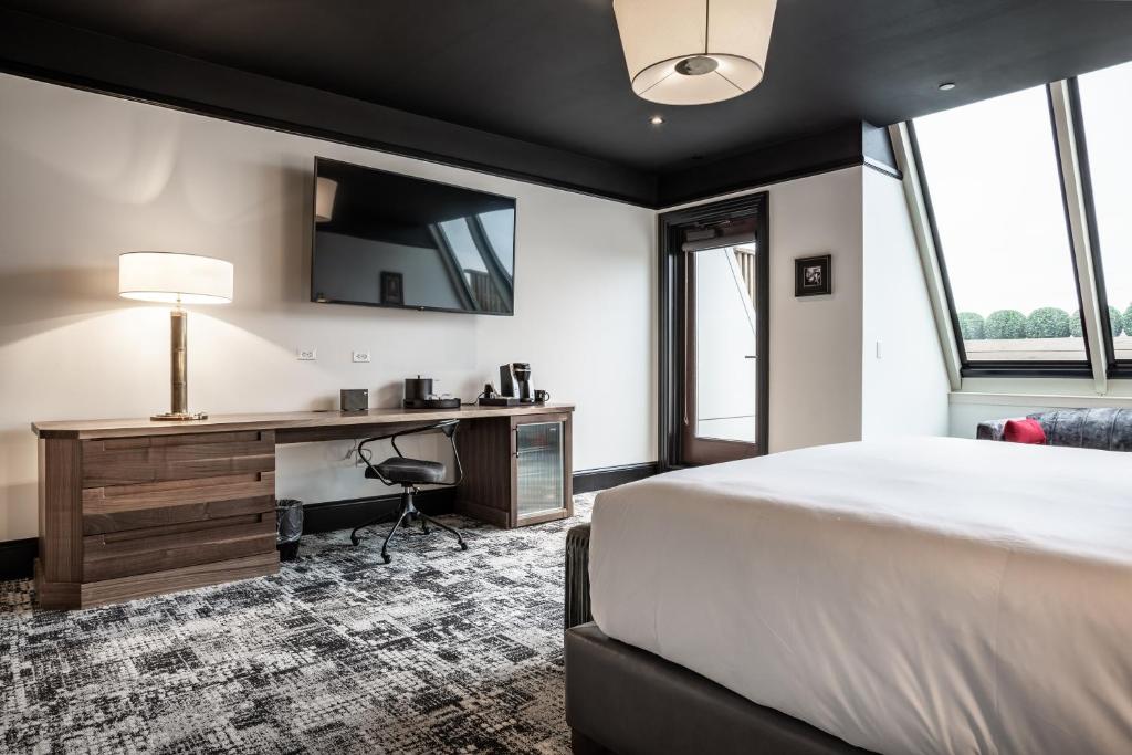 A bed or beds in a room at Bottleworks Hotel