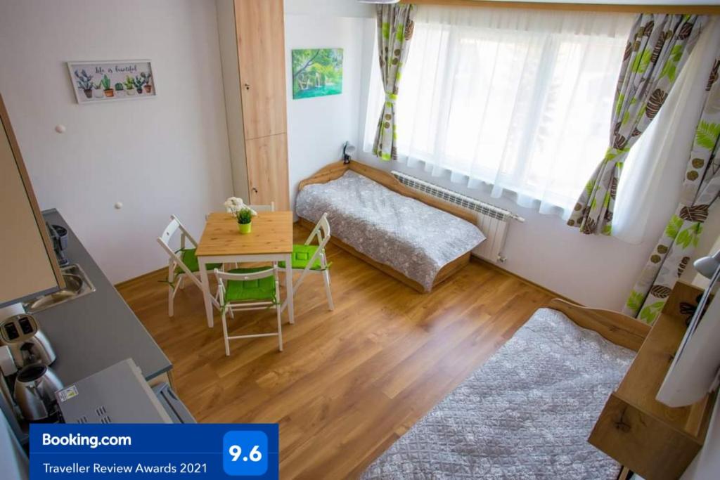 a small living room with a table and a bed at Apartment IVA - Iglika 2 in Borovets