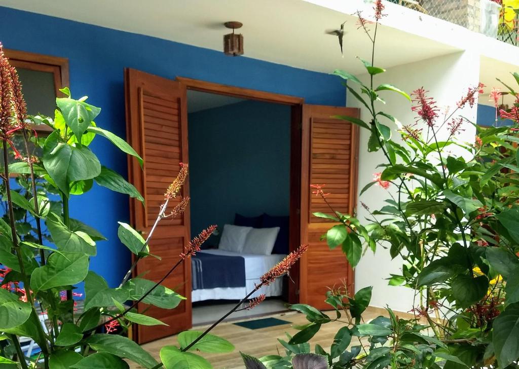 Zimmer mit blauer Wand und einem Bett in der Unterkunft Pousada Casa Viva a Vida in Lençóis