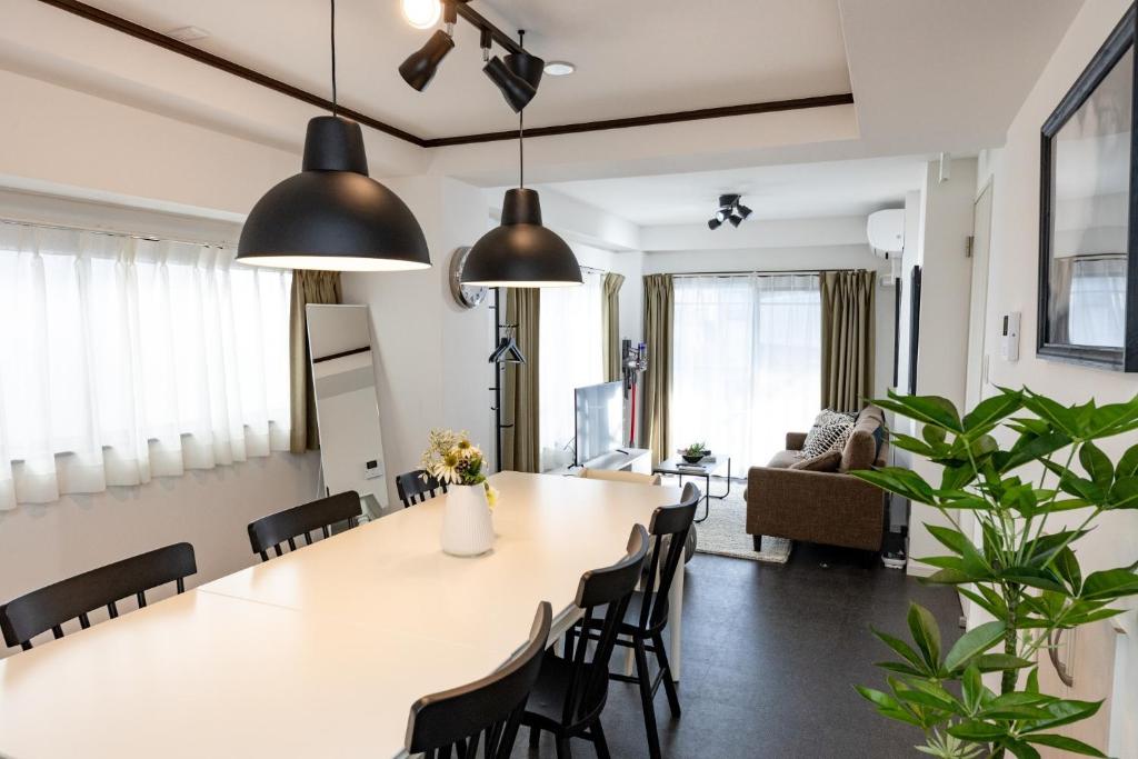 a dining room and living room with a large table and chairs at CASA SHINAGAWA UNO - Vacation STAY 18212v in Tokyo