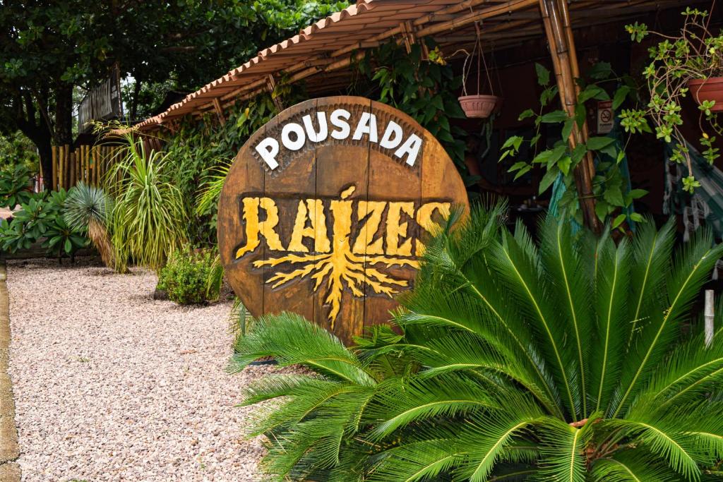 a sign that says pucadia raffles in a garden at Pousada Raizes in Sao Jorge