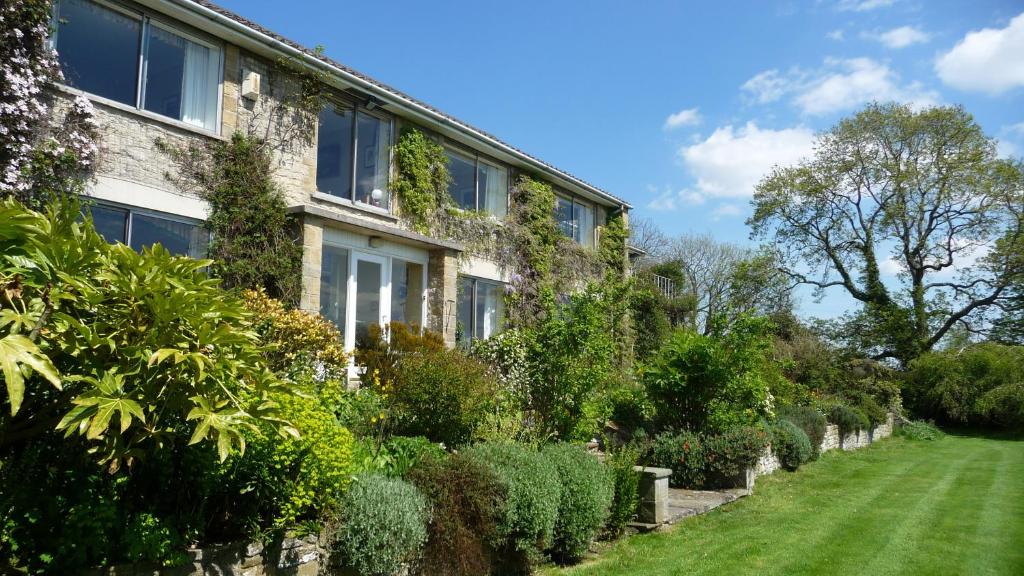 a house with a garden in front of it at Shallowdale House in Helmsley