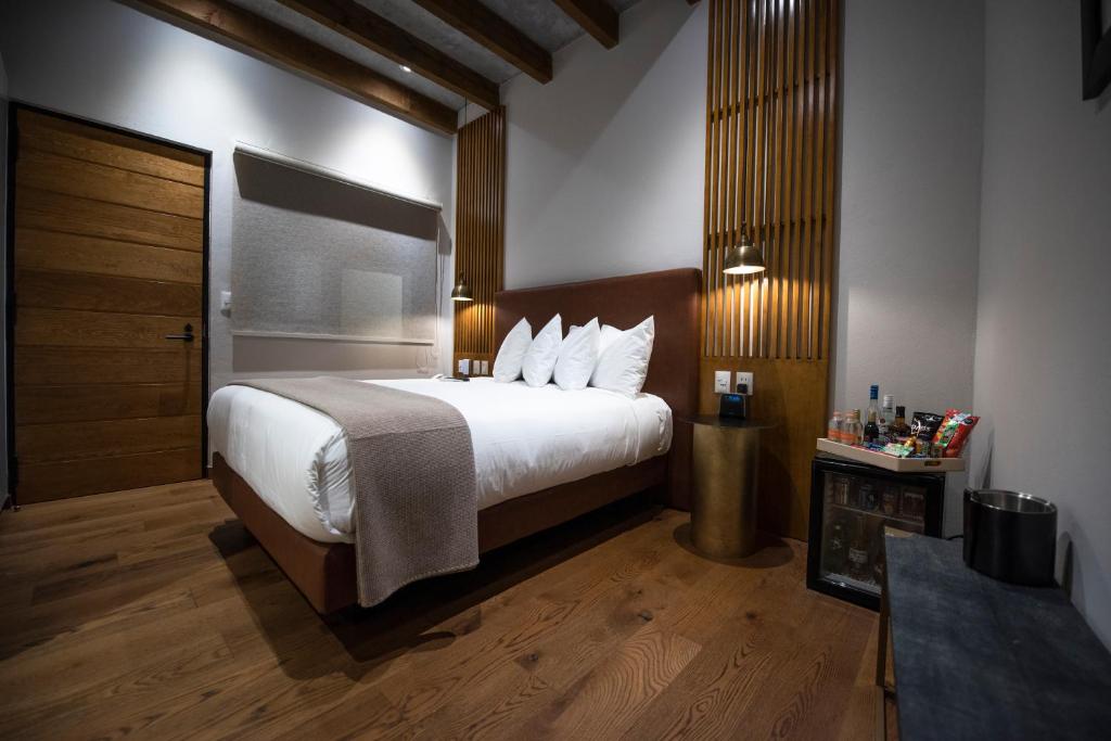 Postel nebo postele na pokoji v ubytování Hotel Madi