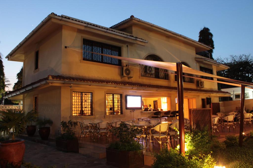 a house with tables and chairs in front of it at Moffat Court Boutique Hotel in Mombasa