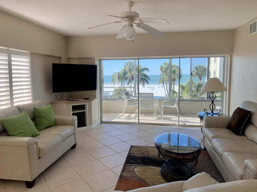 a living room with couches and a flat screen tv at Island House Beach Resor 13N in Point O'Rocks