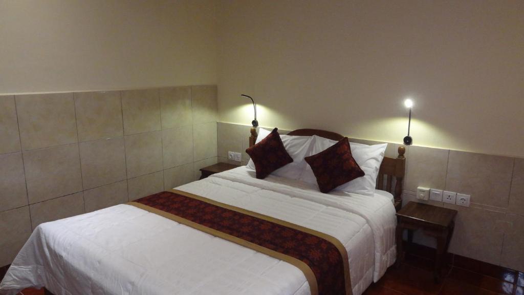 Postel nebo postele na pokoji v ubytování Sunarta House Homestay
