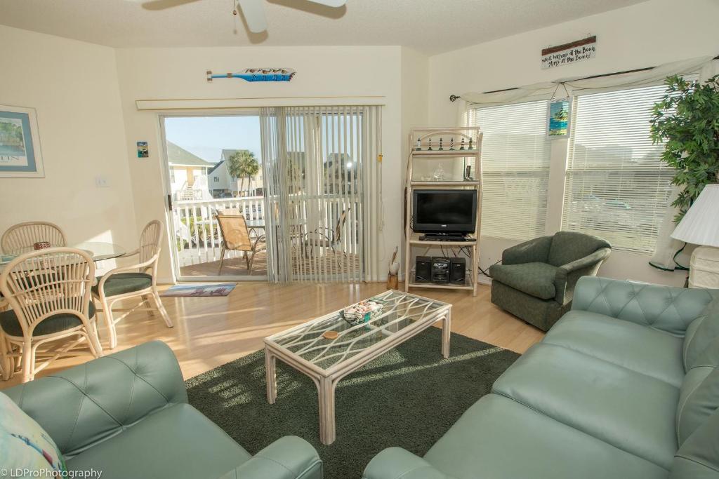 a living room with a couch and a table at Sandpiper Cove #9226 Condo in Destin