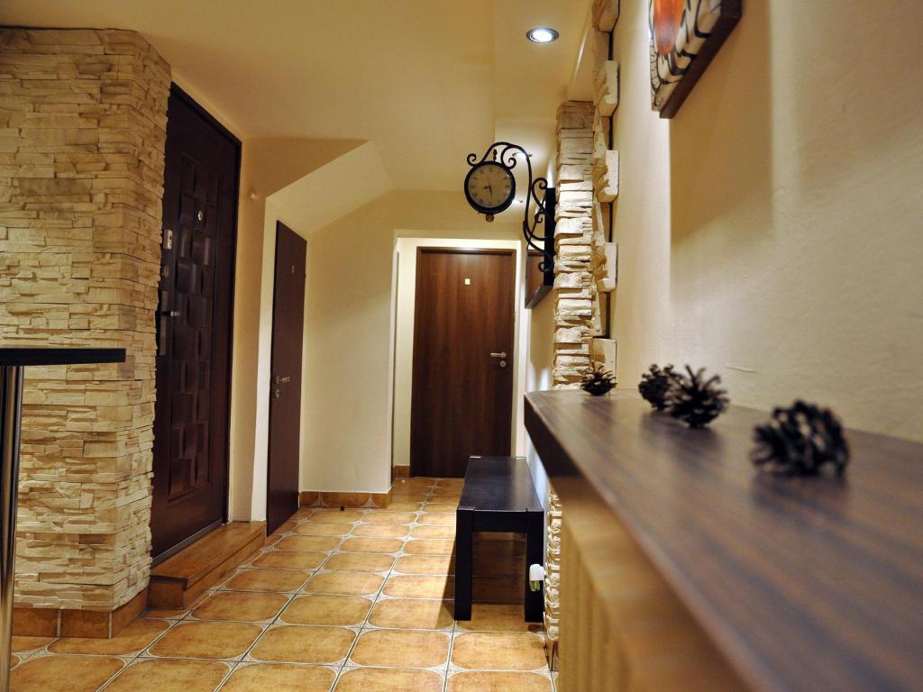 a hallway of a home with a stone wall at Najlepsze Miejsce - pokoje i apartamenty w Krakowie in Kraków