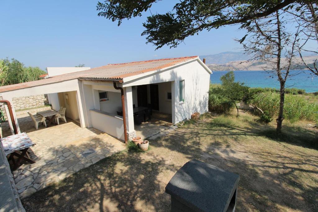 a small white house with a view of the water at Apartment Marija in Kolan