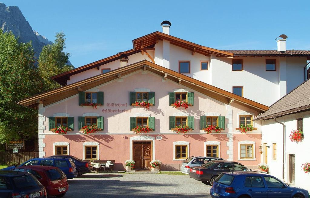 a building with cars parked in front of it at Gästehaus Wöbelerhof in Ehrwald