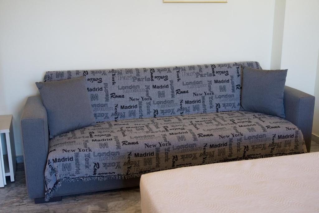 a couch covered in boxes in a living room at Prince Studios in Sami