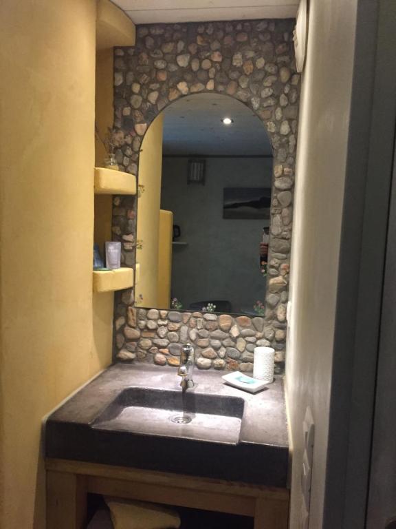 a bathroom with a sink and a mirror at chambre d’hôtes des oliviers in La Roque-sur-Cèze