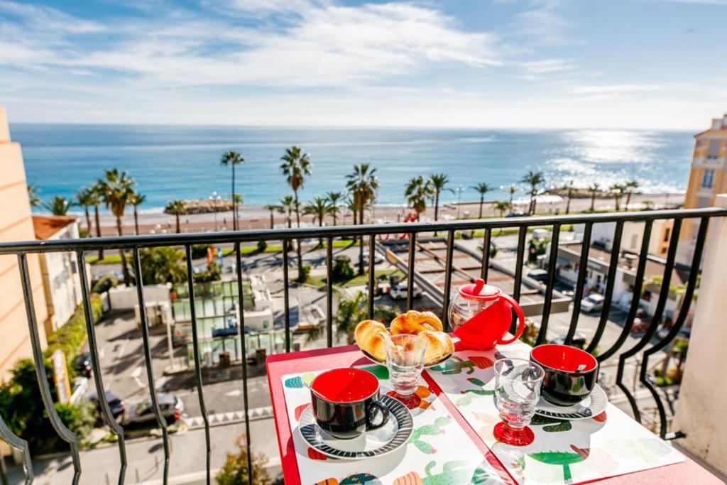 a table with food and a view of the ocean at TAMARIS AP4206 By Riviera Holiday Homes in Nice
