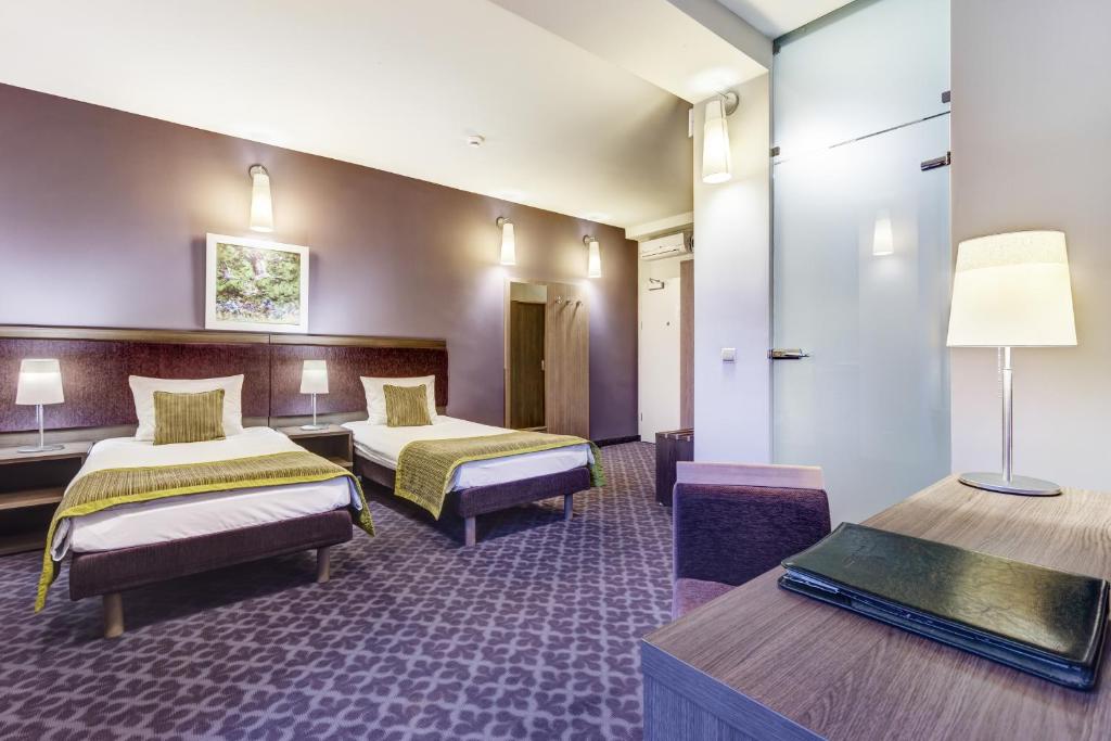 Postel nebo postele na pokoji v ubytování Hotel Metropol