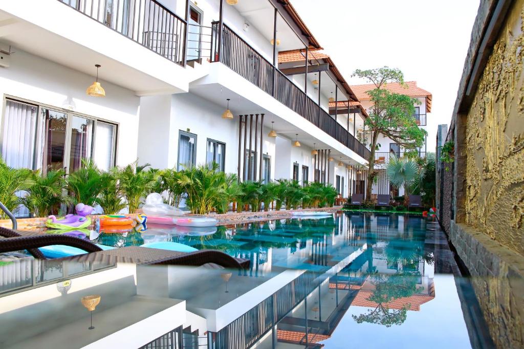 a swimming pool in the middle of a building at Aurora House in Phú Quốc