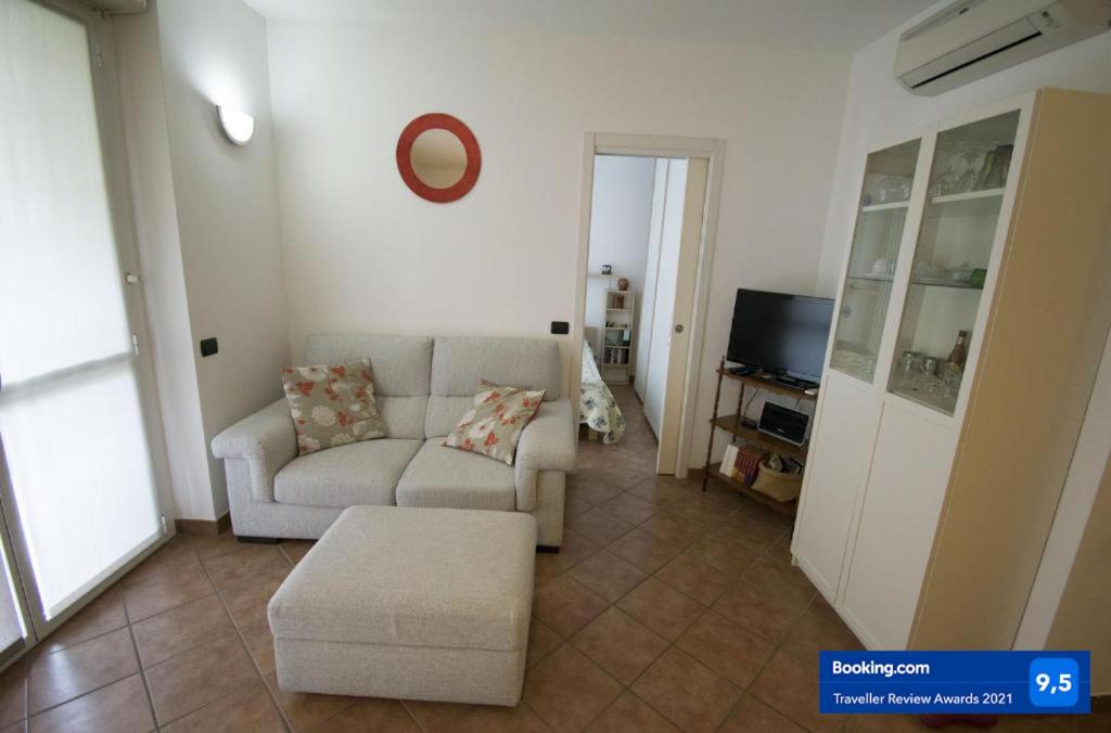 a living room with a couch and a tv at Gaia house in Milan