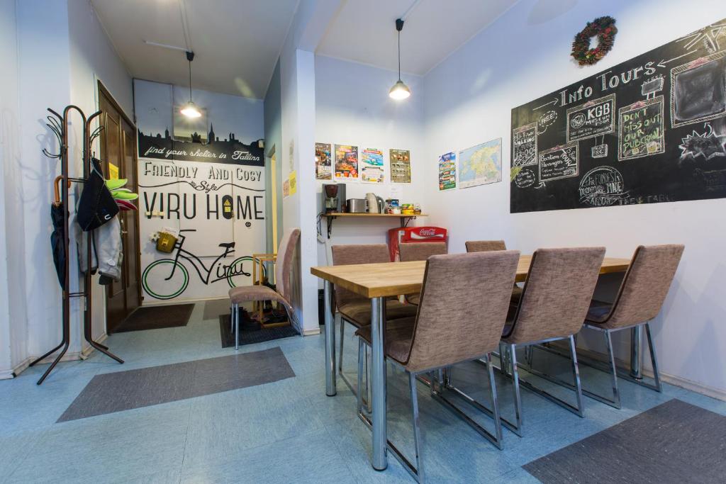 a dining room with a wooden table and chairs at Viru Backpackers Hostel in Tallinn
