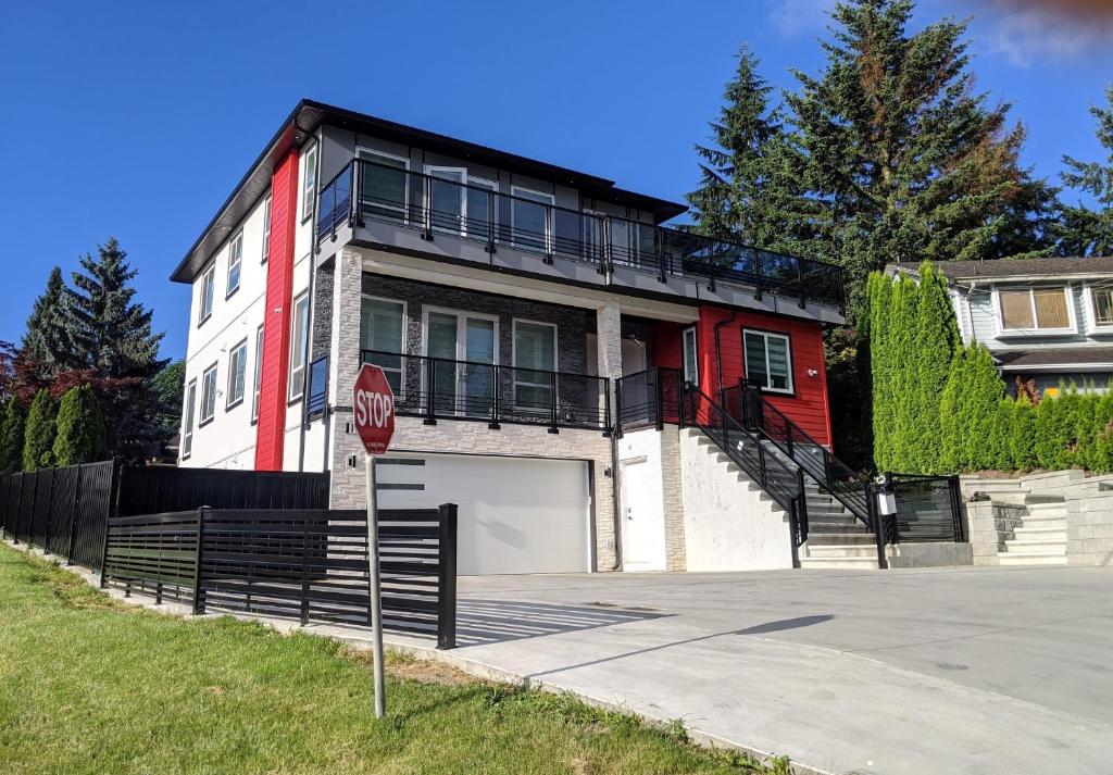 a house with a stop sign in front of it at Modern & Luxurious Suites in Surrey in Surrey