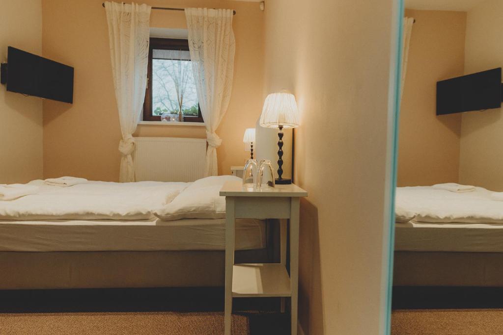 Postel nebo postele na pokoji v ubytování Penzion Nový Rybník