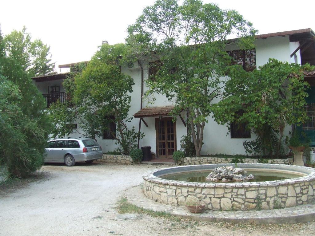 a house with a car parked in front of it at Tenuta La Volpe in Miglionico