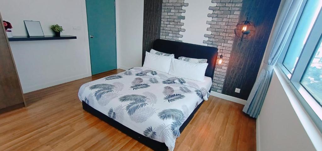 a bedroom with a bed with a black and white comforter at Signature Apartment at Summer Suites klcc in Kuala Lumpur
