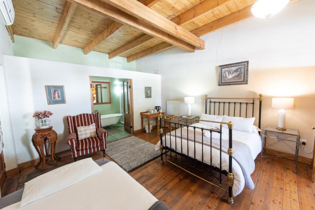 a bedroom with a bed and a living room at Leo Guest House in Robertson
